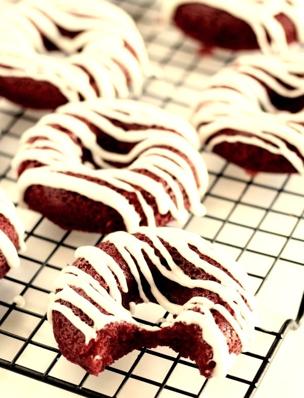 Red Velvet Donuts Beautiful red velvet donuts made from scratch, baked, and topped with a cream cheese frosting.